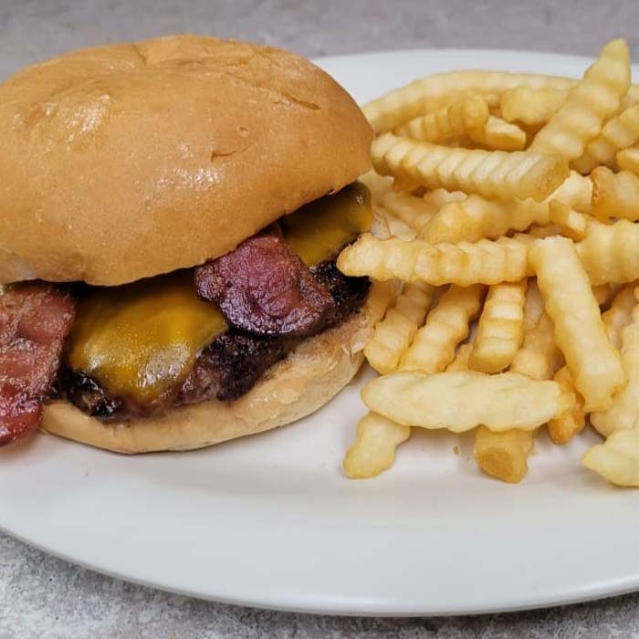 Bacon cheeseburger served with crinkle cut French fries at Wiggly Field & Dome restaurant, sports bar and volleyball courts in Weston, WI