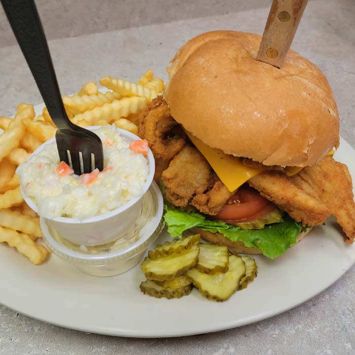 Friday fish fry sandwich, coleslaw served with crinkle cut French fries at Wiggly Field & Dome restaurant, sports bar and volleyball courts in Weston, WI