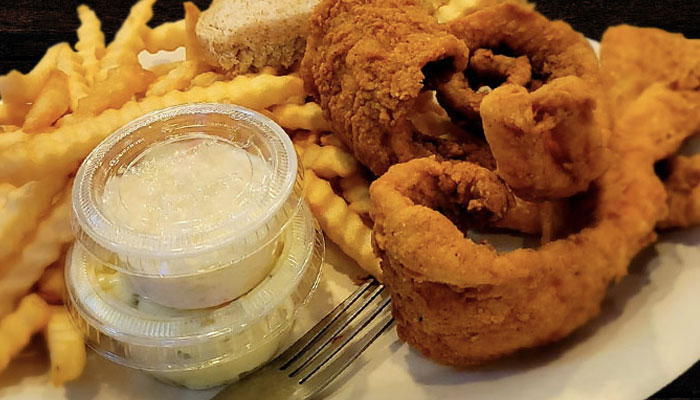 Friday fish fry, coleslaw served with crinkle cut French fries at Wiggly Field & Dome restaurant, sports bar and volleyball courts in Weston, WI